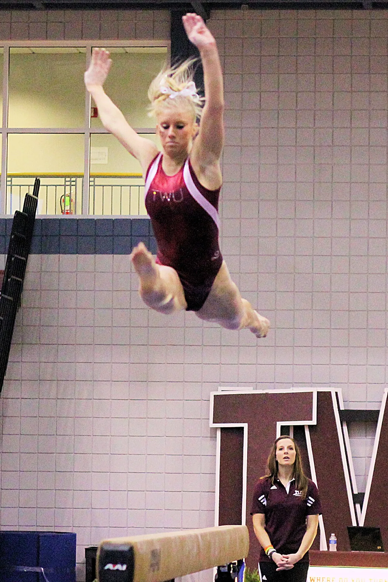 Adult gymnast performing on a balance beam